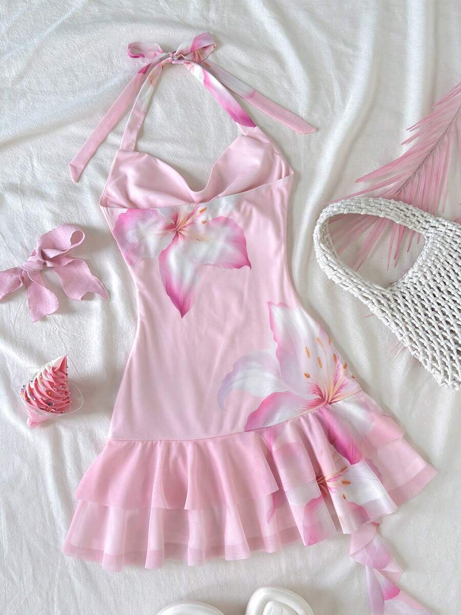 Tween girls sleeveless halter mini dress with ruffle tiered details, flounce hem, slim fit, lined body, and vacation-inspired plant print in khaki and pink tones.