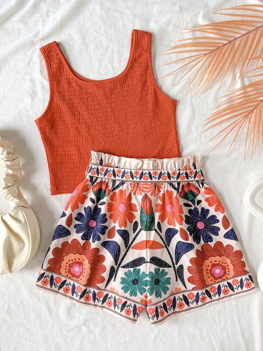 Tween girls 2-piece summer set featuring a turquoise blue ribbed tank top and tropical leaf pattern belted shorts.