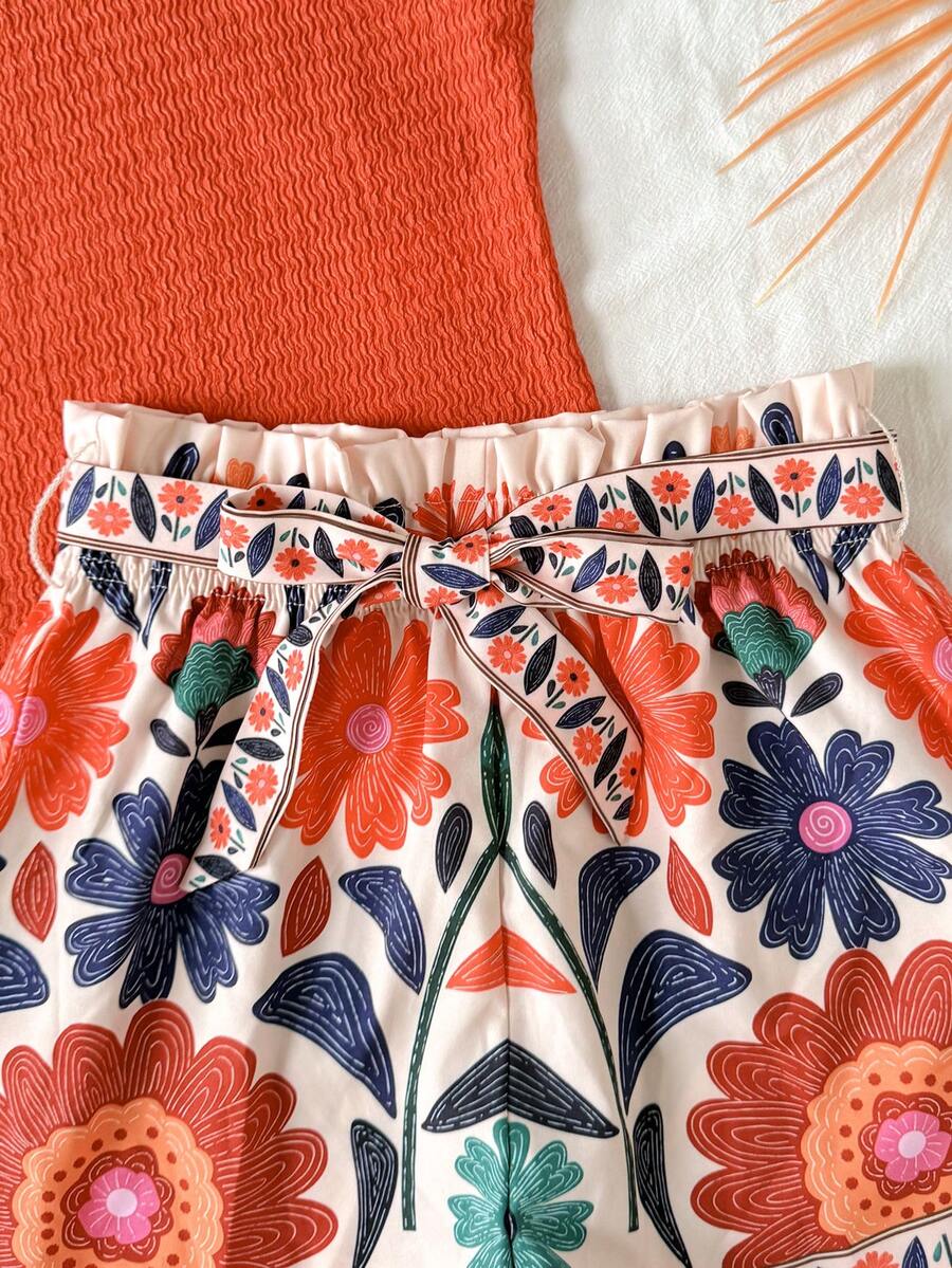 Tween girls 2-piece summer set featuring a turquoise blue ribbed tank top and tropical leaf pattern belted shorts.