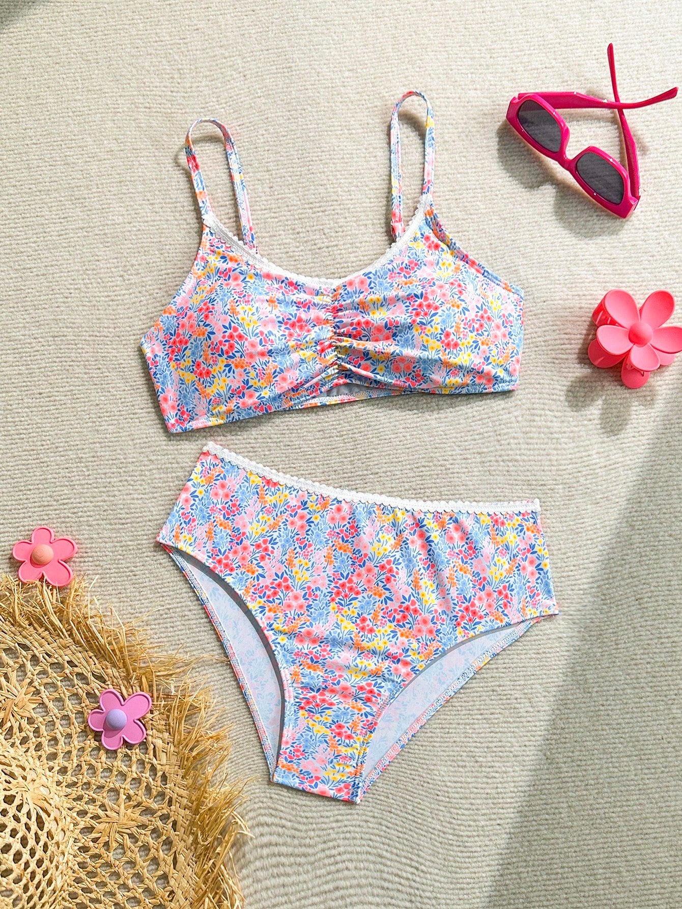 Tween girls 2-piece ditsy floral bikini set featuring a spaghetti strap top with center string detail and matching bottoms with side strings, designed for swimming, vacation, and summer wear.