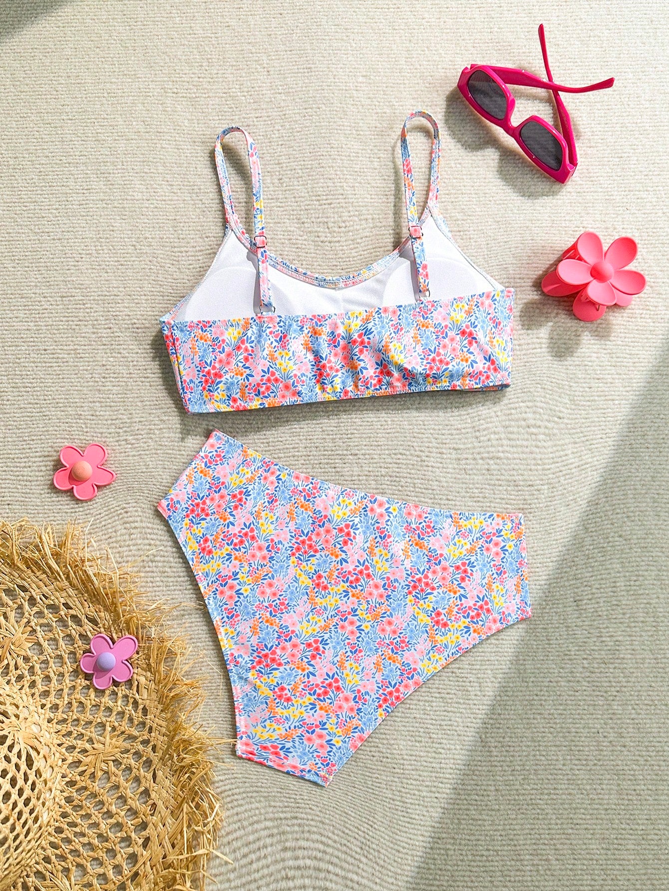 Tween girls 2-piece ditsy floral bikini set featuring a spaghetti strap top with center string detail and matching bottoms with side strings, designed for swimming, vacation, and summer wear.