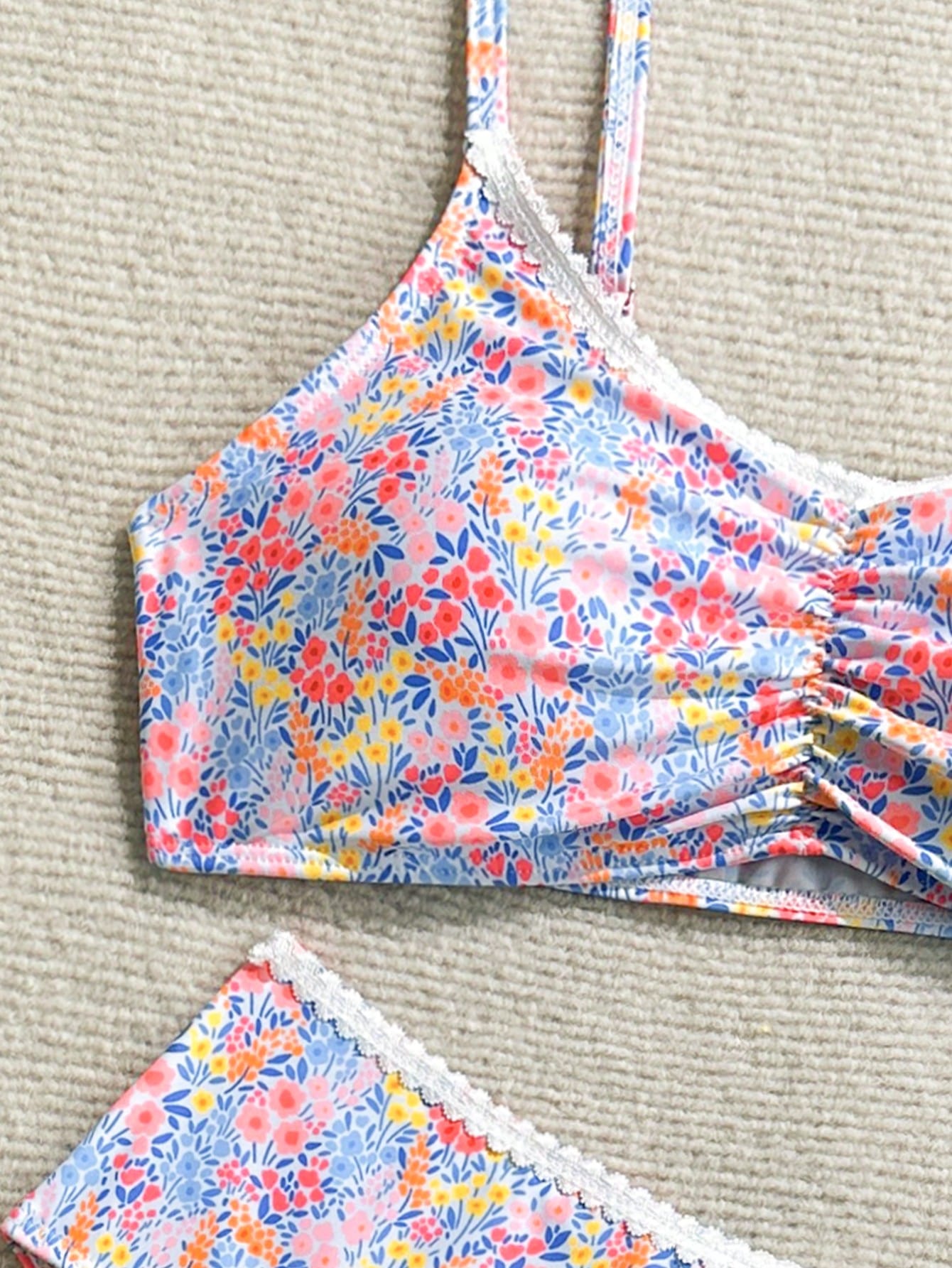Tween girls 2-piece ditsy floral bikini set featuring a spaghetti strap top with center string detail and matching bottoms with side strings, designed for swimming, vacation, and summer wear.