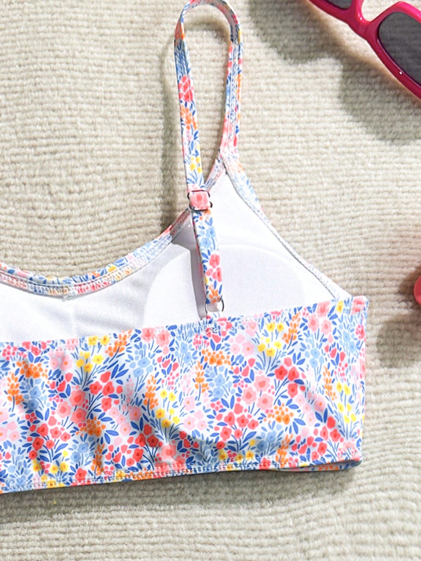Tween girls 2-piece ditsy floral bikini set featuring a spaghetti strap top with center string detail and matching bottoms with side strings, designed for swimming, vacation, and summer wear.