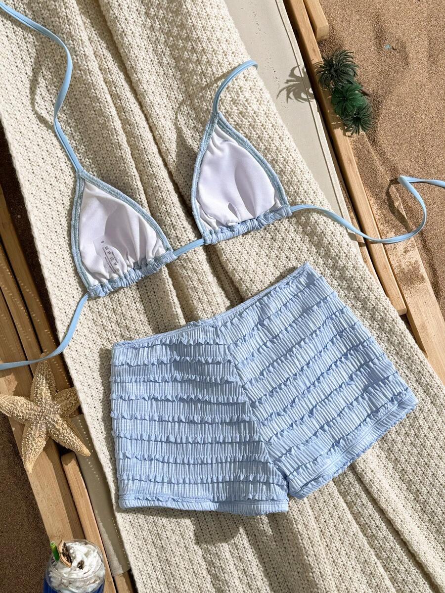 Women's apricot two-piece swimsuit set with a halter tie-back top and matching high stretch shorts.