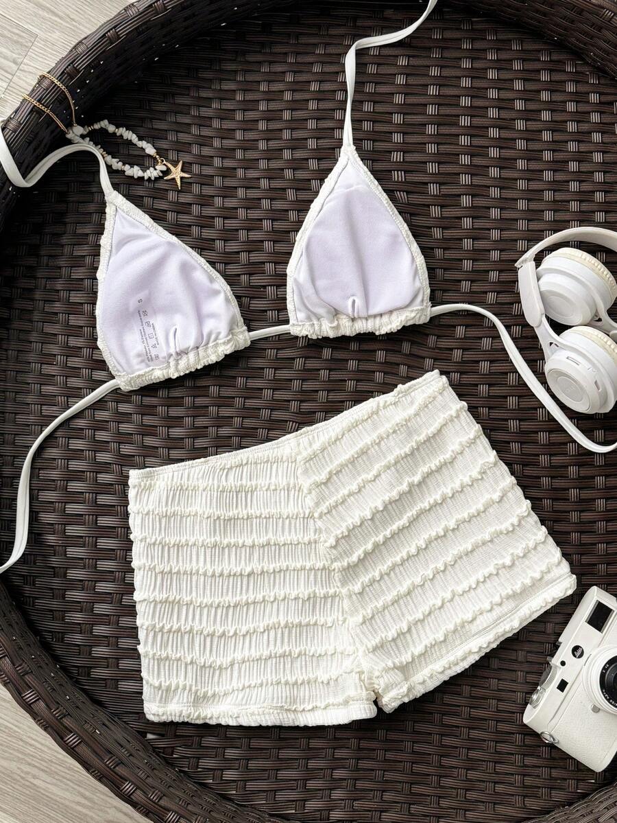 Women's apricot two-piece swimsuit set with a halter tie-back top and matching high stretch shorts.