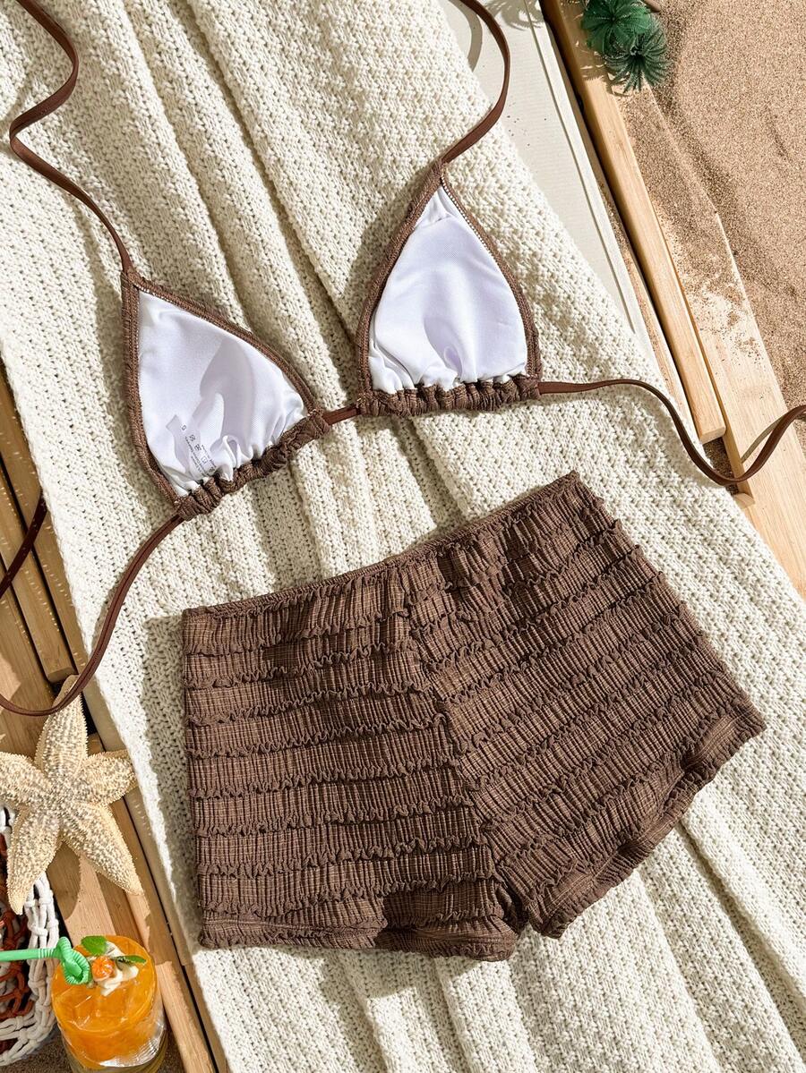 Women's apricot two-piece swimsuit set with a halter tie-back top and matching high stretch shorts.