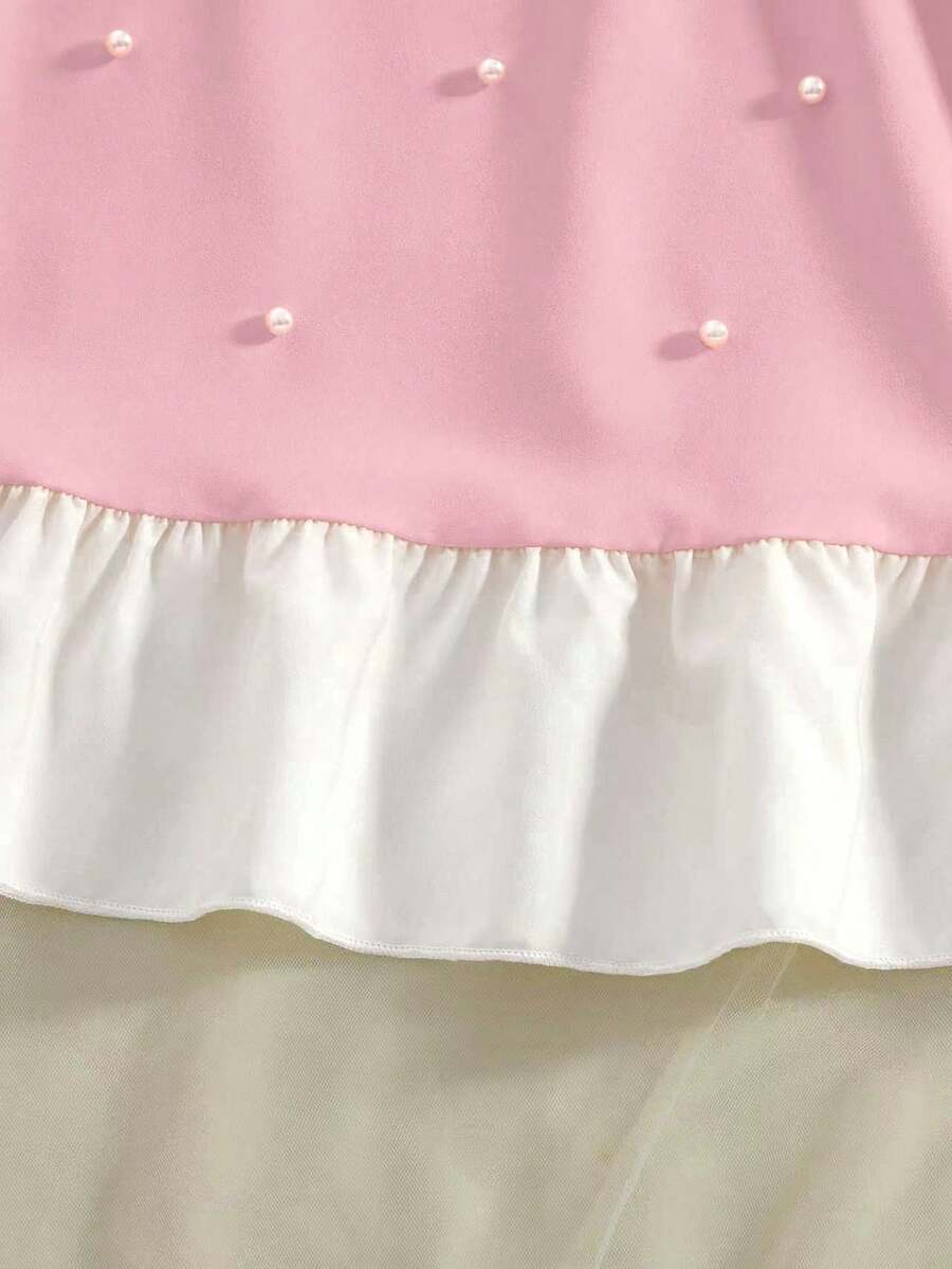 Yellow sleeveless colorblock dress for girls featuring a round neck, ruffle hem, and front bow detail.