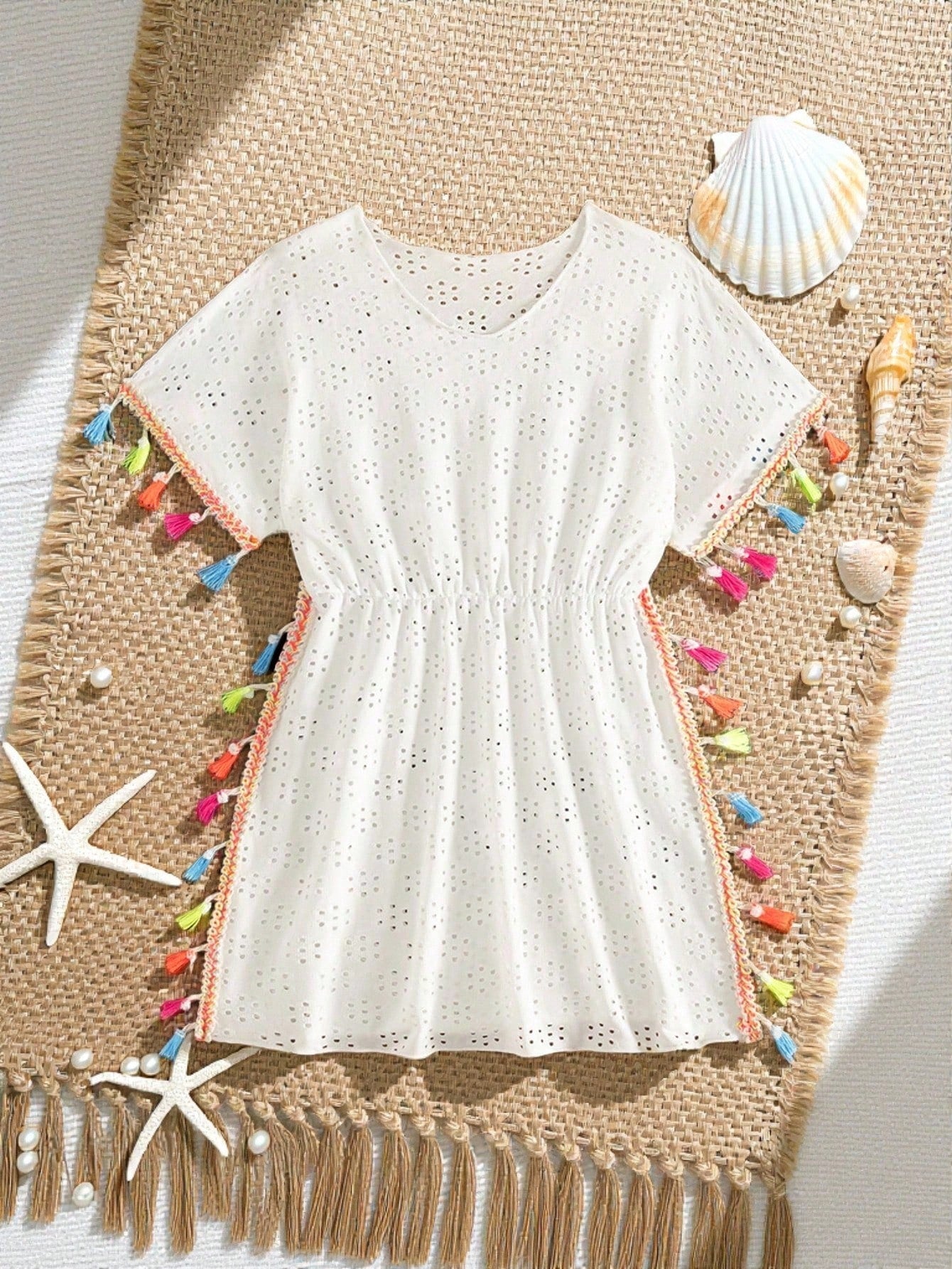 Tween girl white swimsuit cover up with colorful tassel fringe, hollow crochet mesh, round neck, short sleeves, and semi-sheer beach dress style.