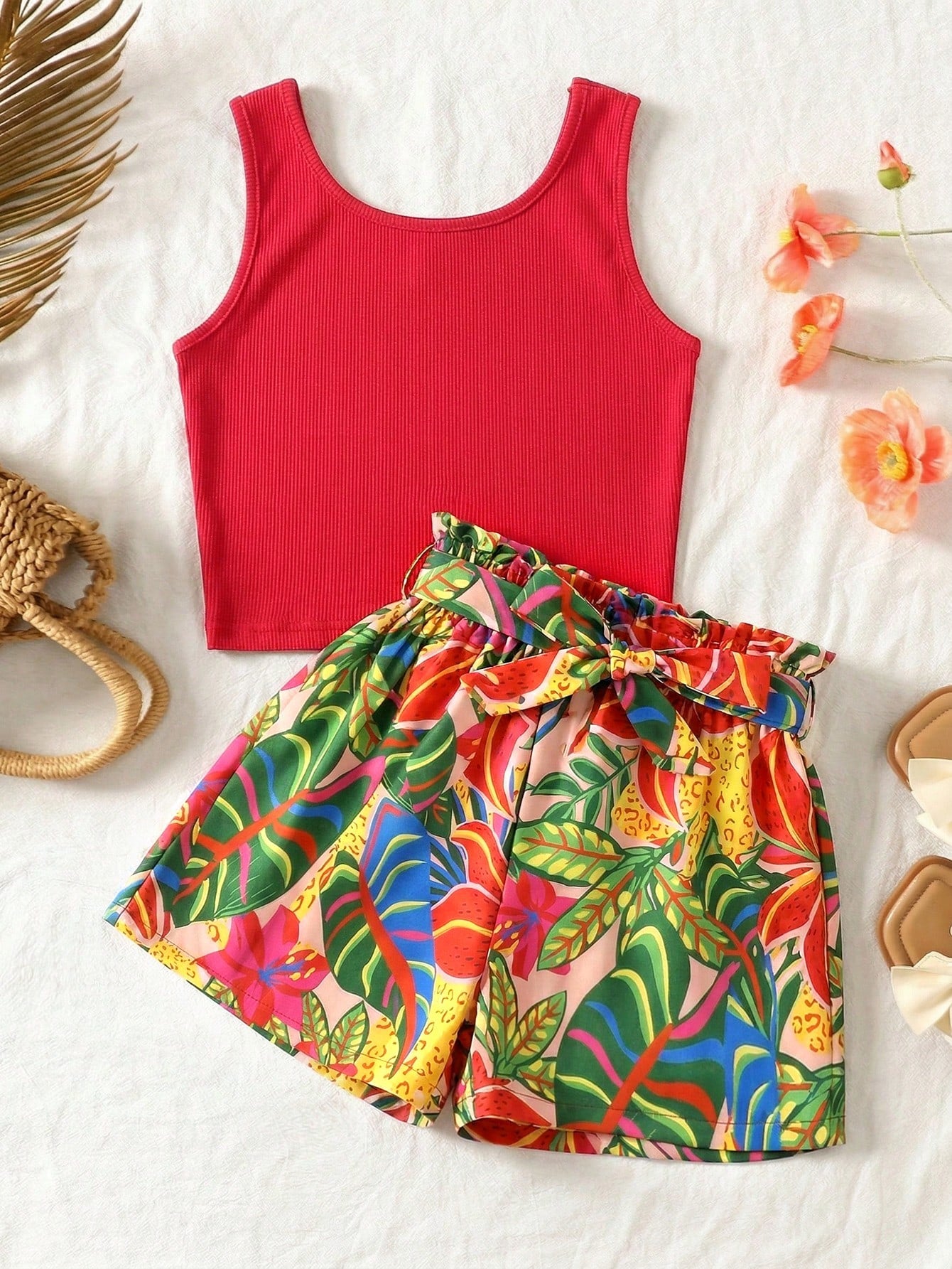 Tween girl wearing a casual 2-piece set featuring a black rib-knit scoop neck tank top and leopard print paperbag waist shorts with a matching belt.