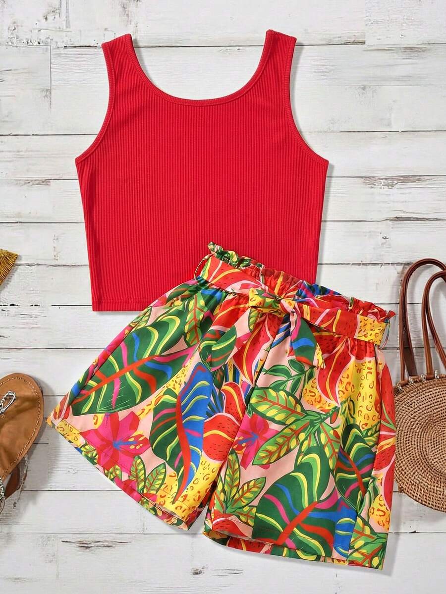 Tween girl wearing a casual 2-piece set featuring a black rib-knit scoop neck tank top and leopard print paperbag waist shorts with a matching belt.