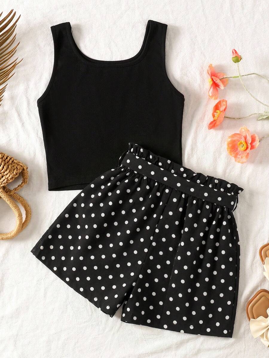 Tween girl wearing a casual 2-piece set featuring a black rib-knit scoop neck tank top and leopard print paperbag waist shorts with a matching belt.