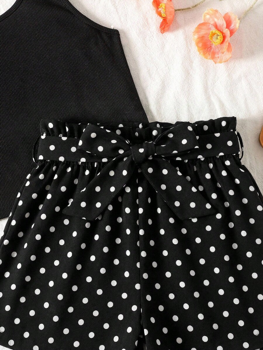 Tween girl wearing a casual 2-piece set featuring a black rib-knit scoop neck tank top and leopard print paperbag waist shorts with a matching belt.