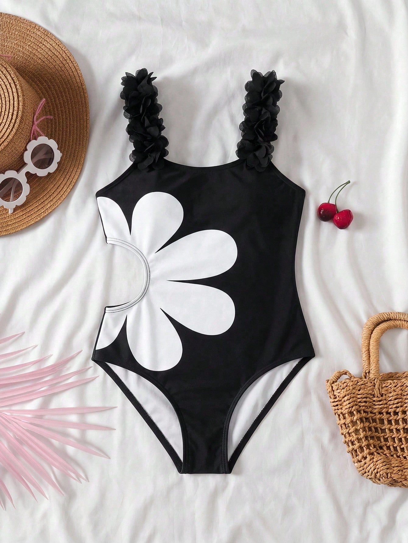 Tween girls' black one-piece swimsuit with floral patchwork all-over print, 3D rose detail, scoop neckline, fitted shape, and lined body for beach and vacation swimwear.