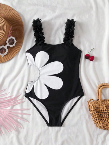 Tween girls' black one-piece swimsuit with floral patchwork all-over print, 3D rose detail, scoop neckline, fitted shape, and lined body for beach and vacation swimwear.