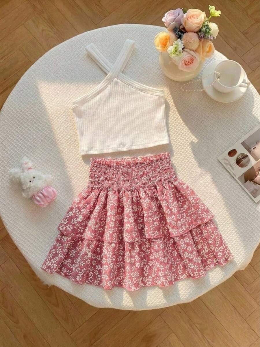 Tween girls blue and white 2-piece set with a striped halter neck vest top and a floral high-waist tiered paperbag skirt.