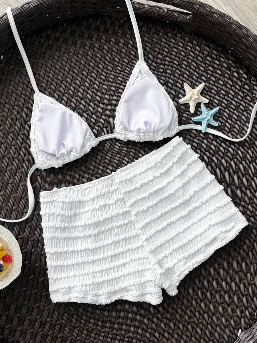 Women's apricot two-piece swimsuit set with a halter tie-back top and matching high stretch shorts.
