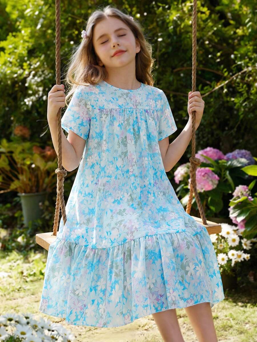 Tween girl wearing an Army Green textured short sleeve smock midi dress with round neck and ruffle flounce hem.