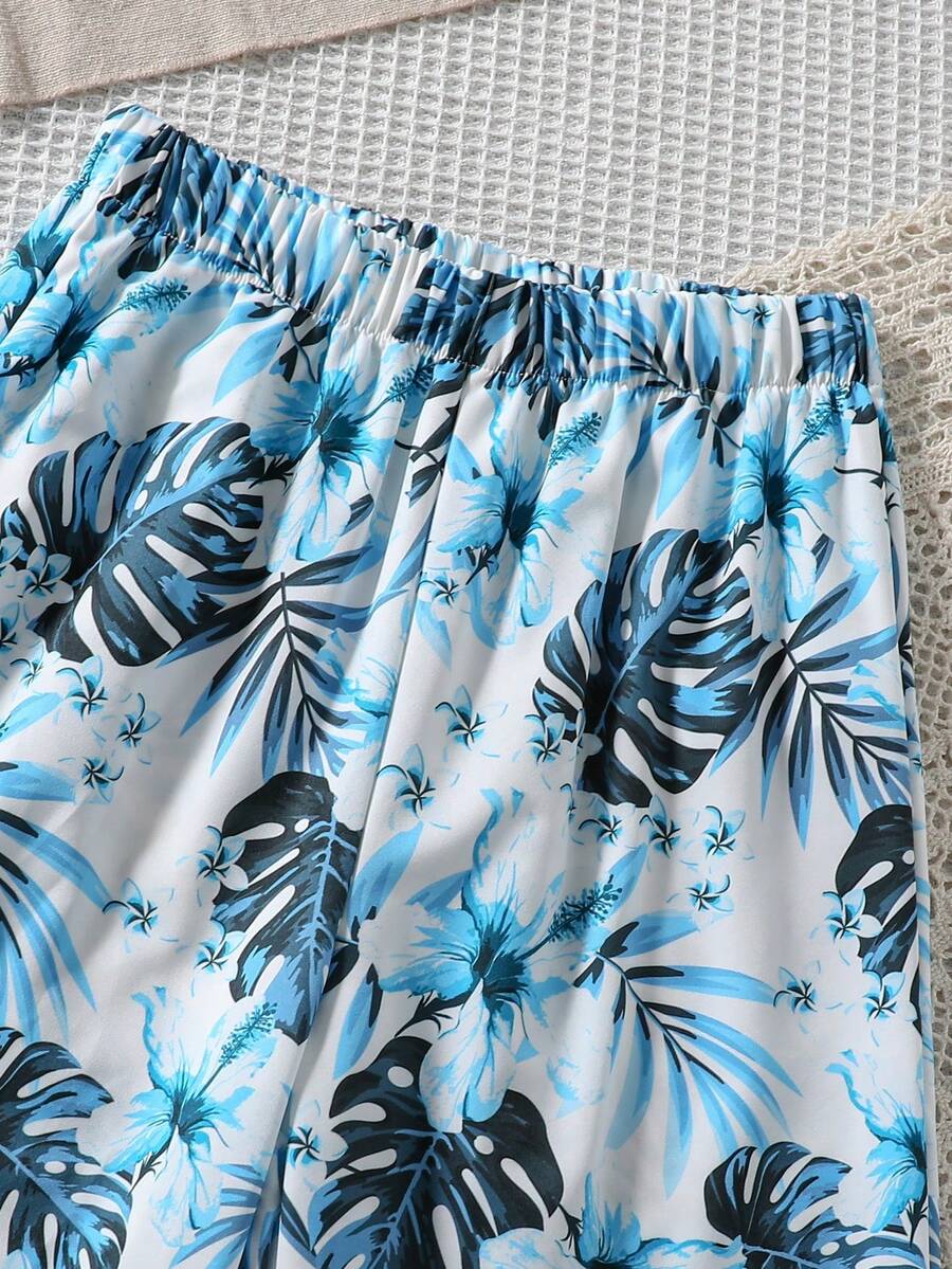Tween girls blue 2-piece vacation outfit set featuring a tiered ruffle spaghetti strap camisole and loose high-waist pants.