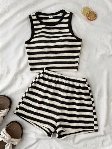 Tween girls black and white two-piece casual summer outfit featuring a rib-knit cropped top with round neck and matching shorts with contrast piping.
