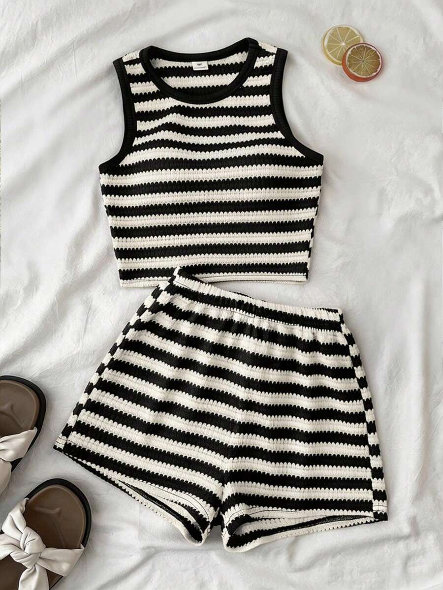 Tween girls black and white two-piece casual summer outfit featuring a rib-knit cropped top with round neck and matching shorts with contrast piping.