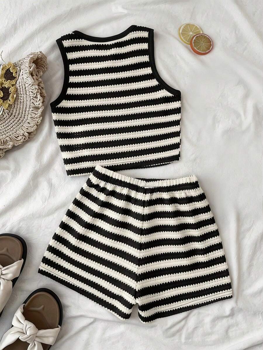Tween girls black and white two-piece casual summer outfit featuring a rib-knit cropped top with round neck and matching shorts with contrast piping.