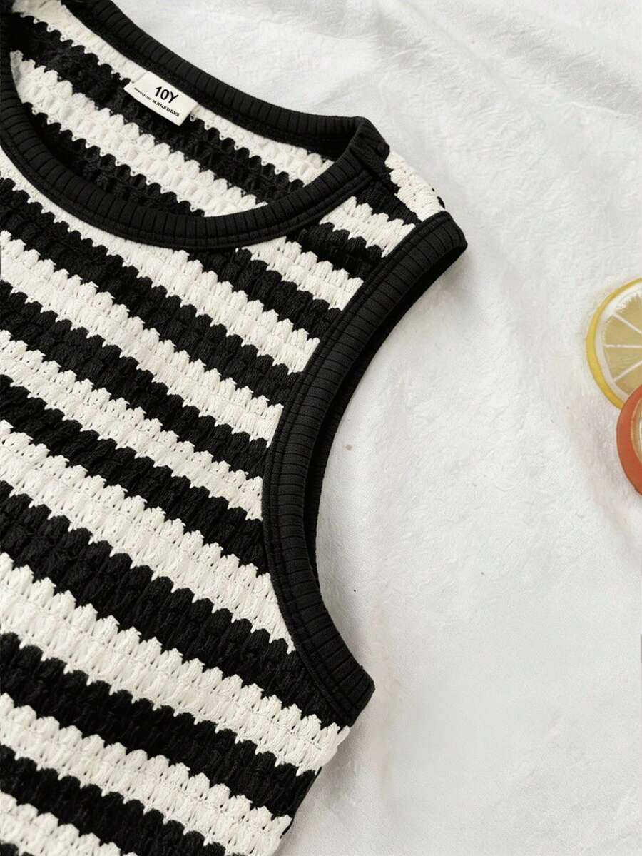Tween girls black and white two-piece casual summer outfit featuring a rib-knit cropped top with round neck and matching shorts with contrast piping.