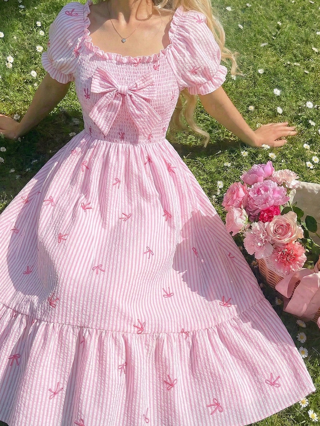 Tween girl wearing a black and white off-the-shoulder floral midi dress featuring short puff sleeves, high waist, and flounce hem.