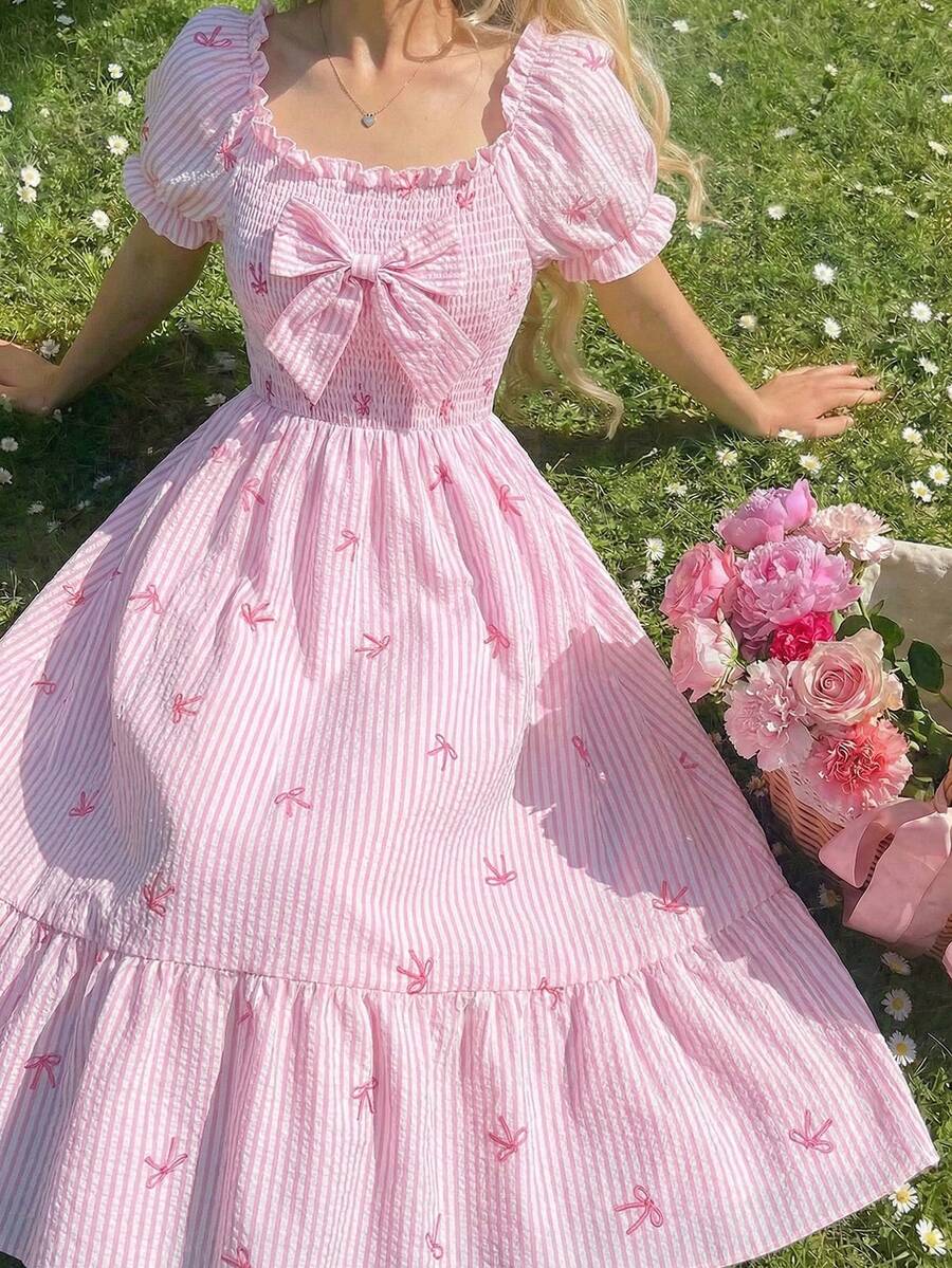 Tween girl wearing a black and white off-the-shoulder floral midi dress featuring short puff sleeves, high waist, and flounce hem.