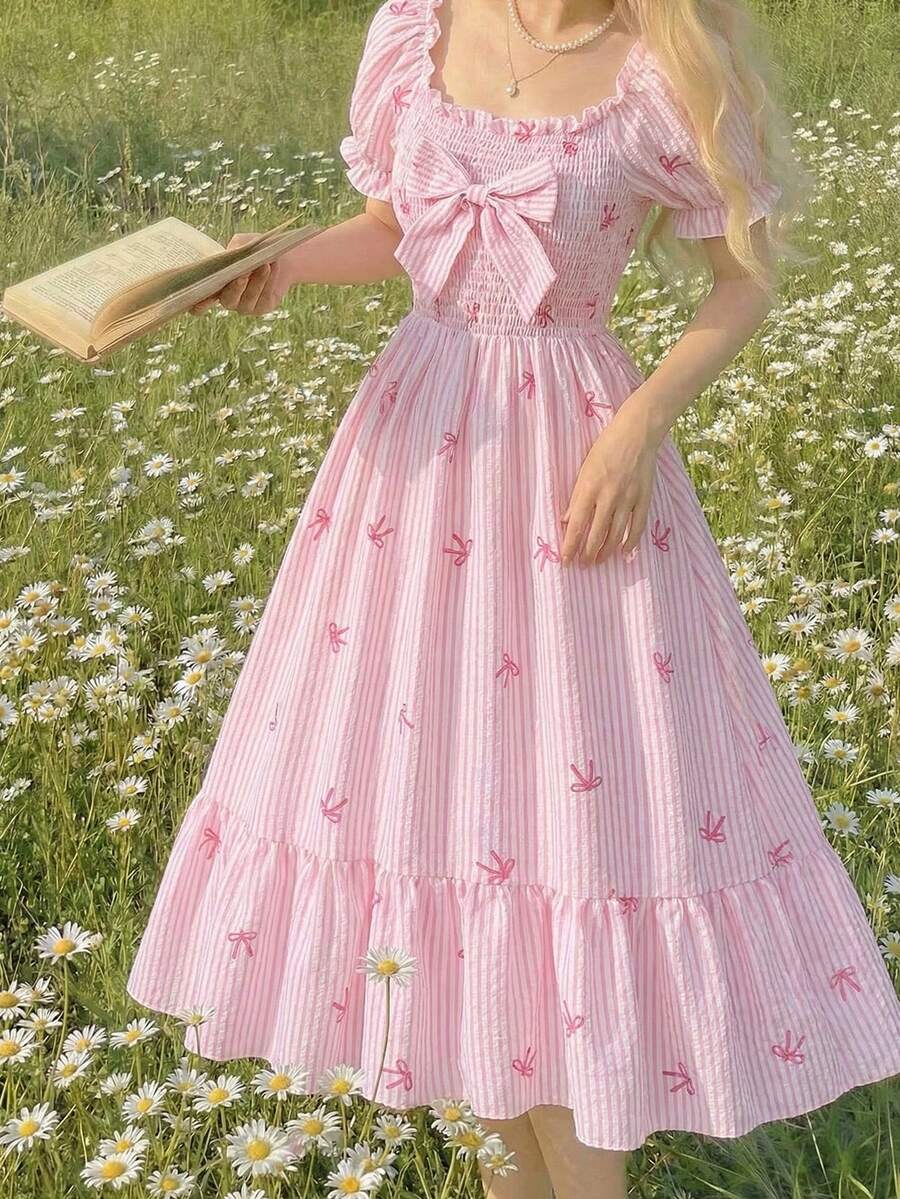 Tween girl wearing a black and white off-the-shoulder floral midi dress featuring short puff sleeves, high waist, and flounce hem.