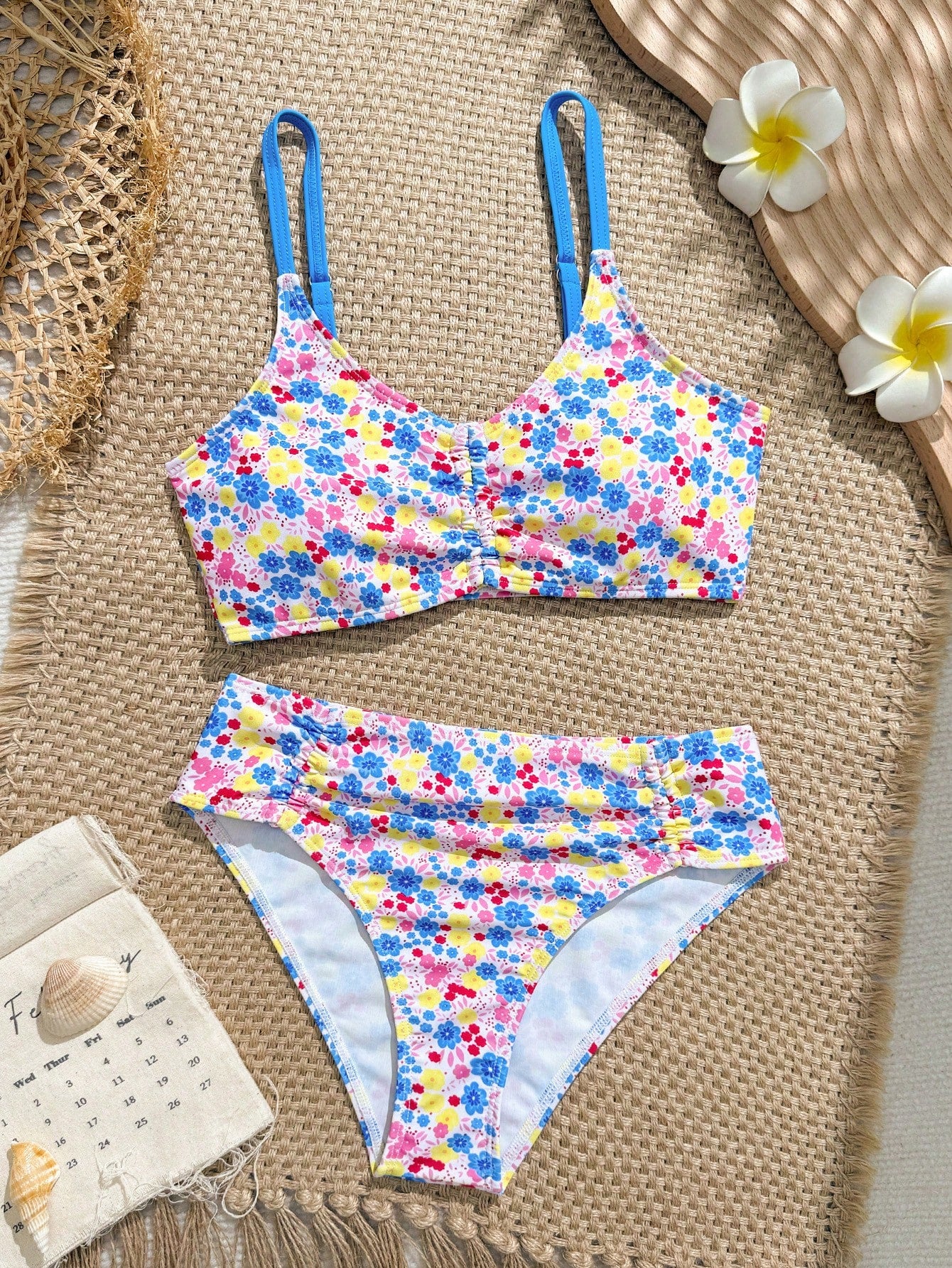 Tween girls 2-piece ditsy floral bikini set featuring a spaghetti strap top with center string detail and matching bottoms with side strings, designed for swimming, vacation, and summer wear.