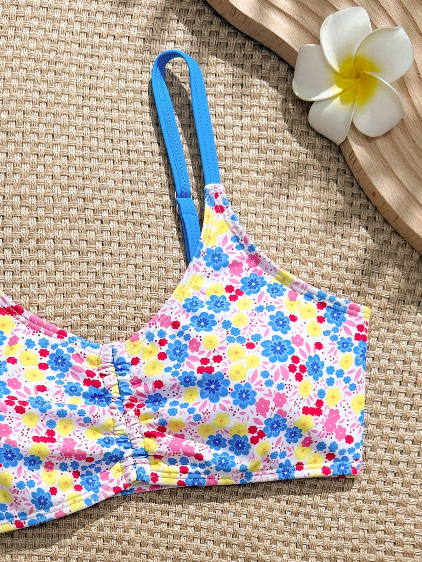 Tween girls 2-piece ditsy floral bikini set featuring a spaghetti strap top with center string detail and matching bottoms with side strings, designed for swimming, vacation, and summer wear.