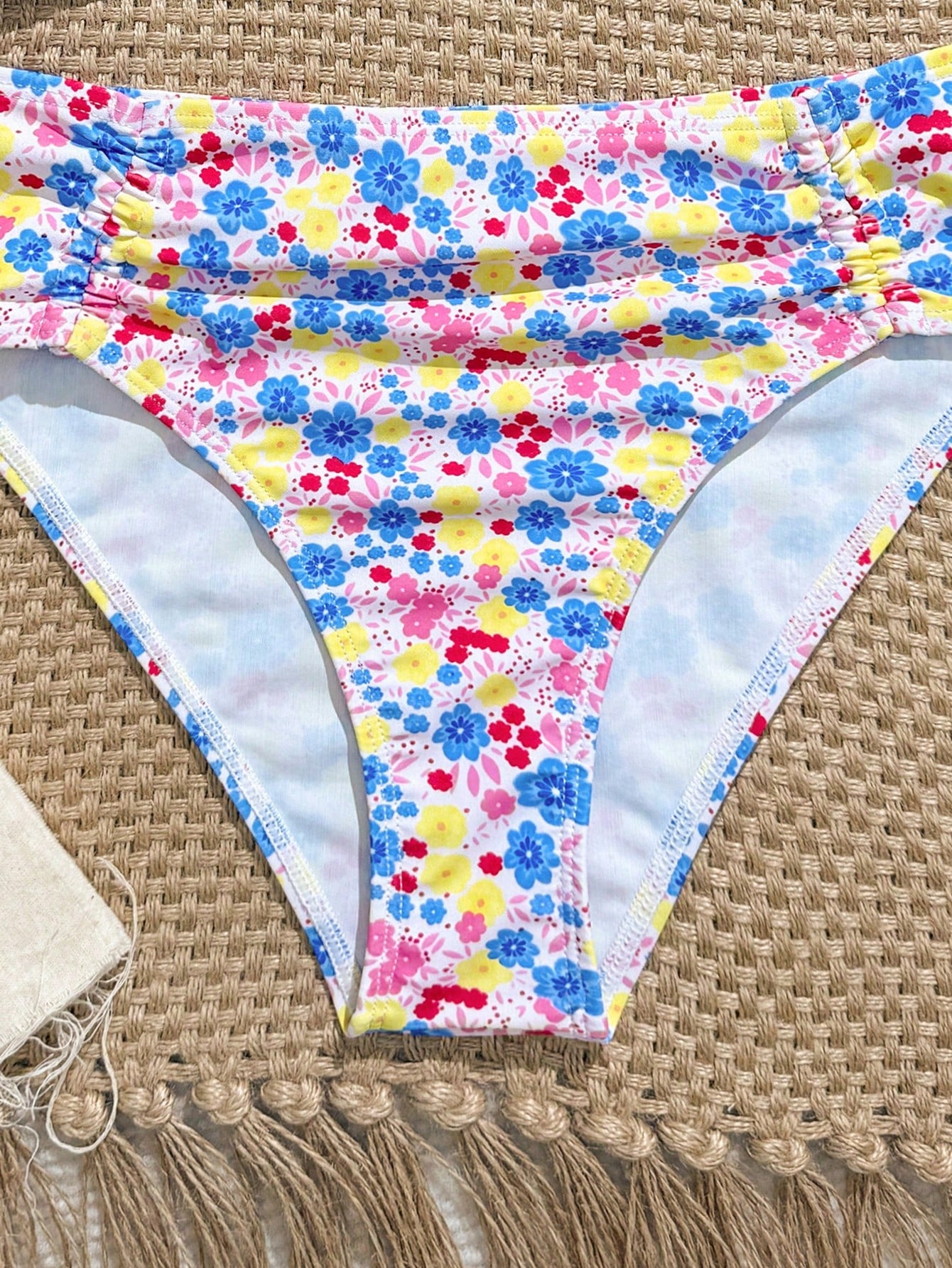 Tween girls 2-piece ditsy floral bikini set featuring a spaghetti strap top with center string detail and matching bottoms with side strings, designed for swimming, vacation, and summer wear.