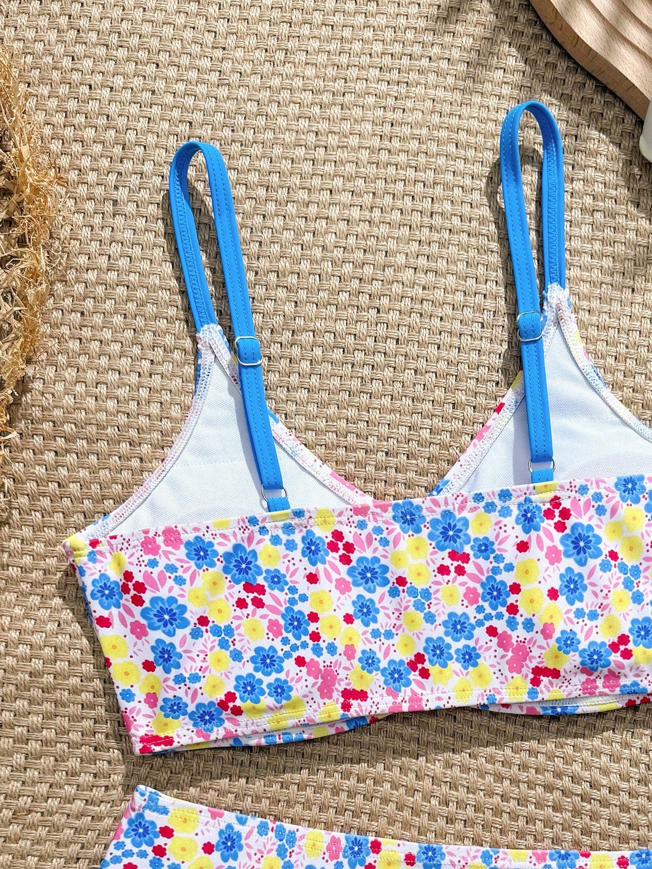 Tween girls 2-piece ditsy floral bikini set featuring a spaghetti strap top with center string detail and matching bottoms with side strings, designed for swimming, vacation, and summer wear.