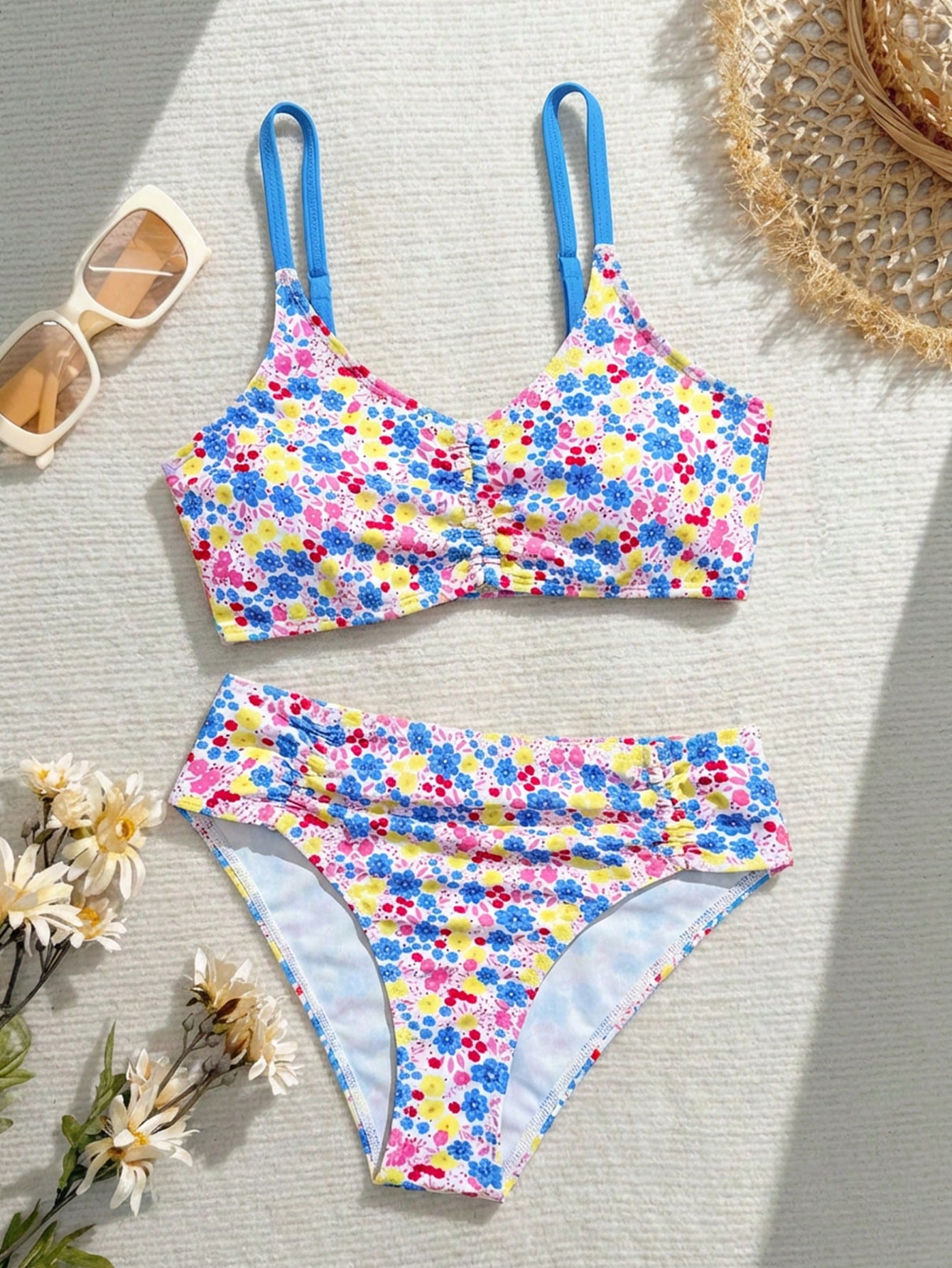 Tween girls 2-piece ditsy floral bikini set featuring a spaghetti strap top with center string detail and matching bottoms with side strings, designed for swimming, vacation, and summer wear.