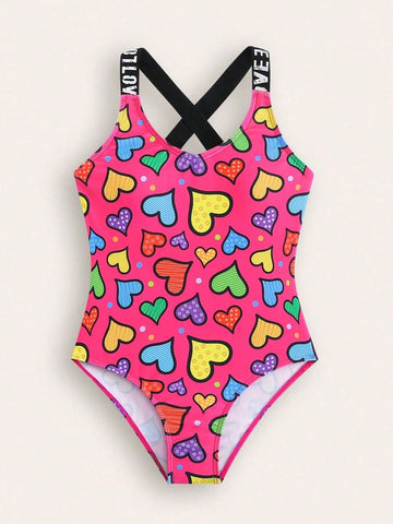 Baby pink girls one-piece swimsuit with ruffle detail, scoop neck, all-over print, and medium-stretch fabric for kids' beach and pool wear.