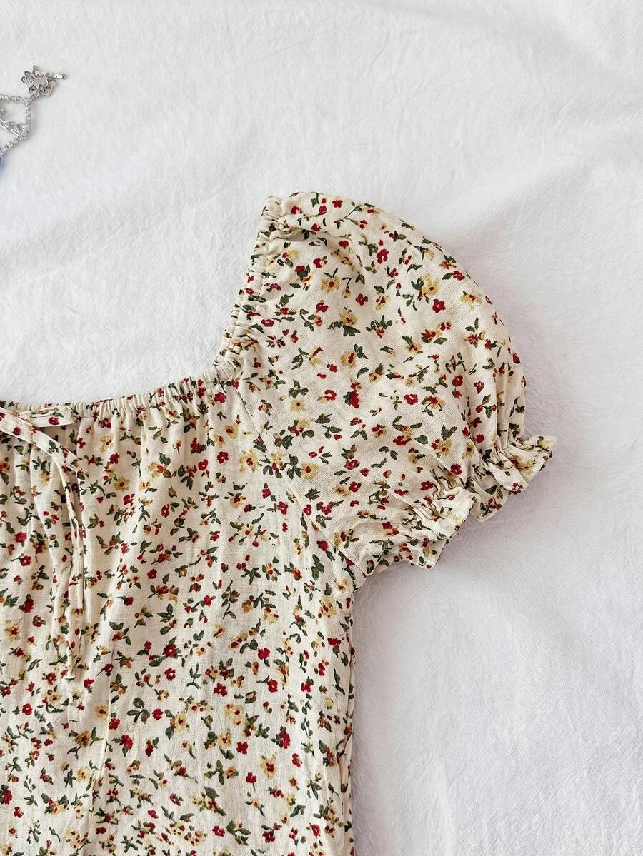 Black floral all-over print midi dress for tween girls featuring puff half sleeves, spaghetti strap neckline, and an A-line silhouette.