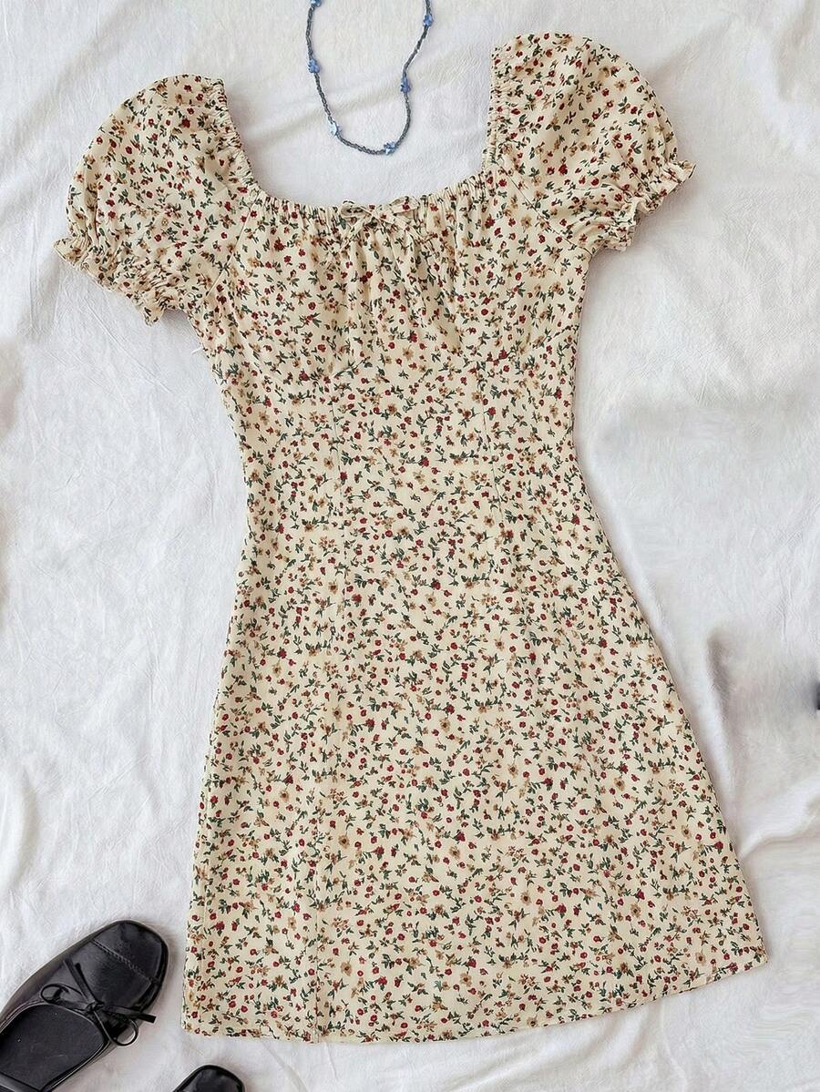 Black floral all-over print midi dress for tween girls featuring puff half sleeves, spaghetti strap neckline, and an A-line silhouette.