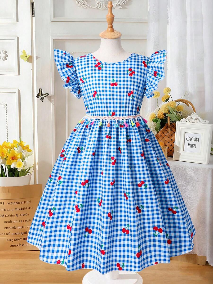 Tween girls blue short smock dress featuring flounce short sleeves, high waist flared hem, round neck, and front bow detail.