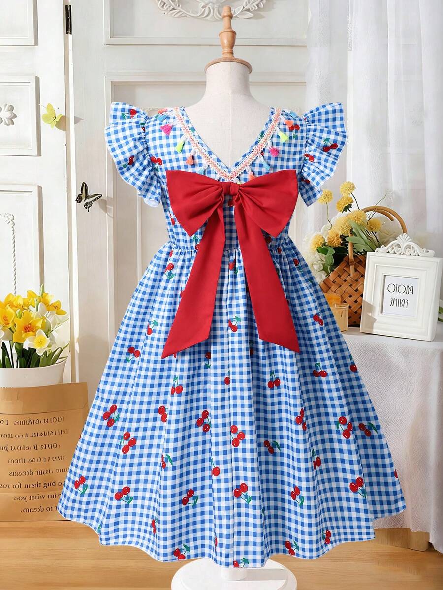 Tween girls blue short smock dress featuring flounce short sleeves, high waist flared hem, round neck, and front bow detail.