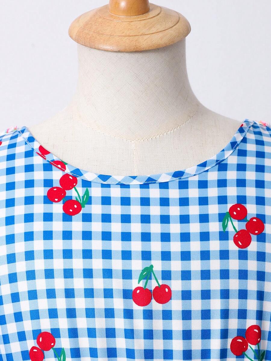 Tween girls blue short smock dress featuring flounce short sleeves, high waist flared hem, round neck, and front bow detail.