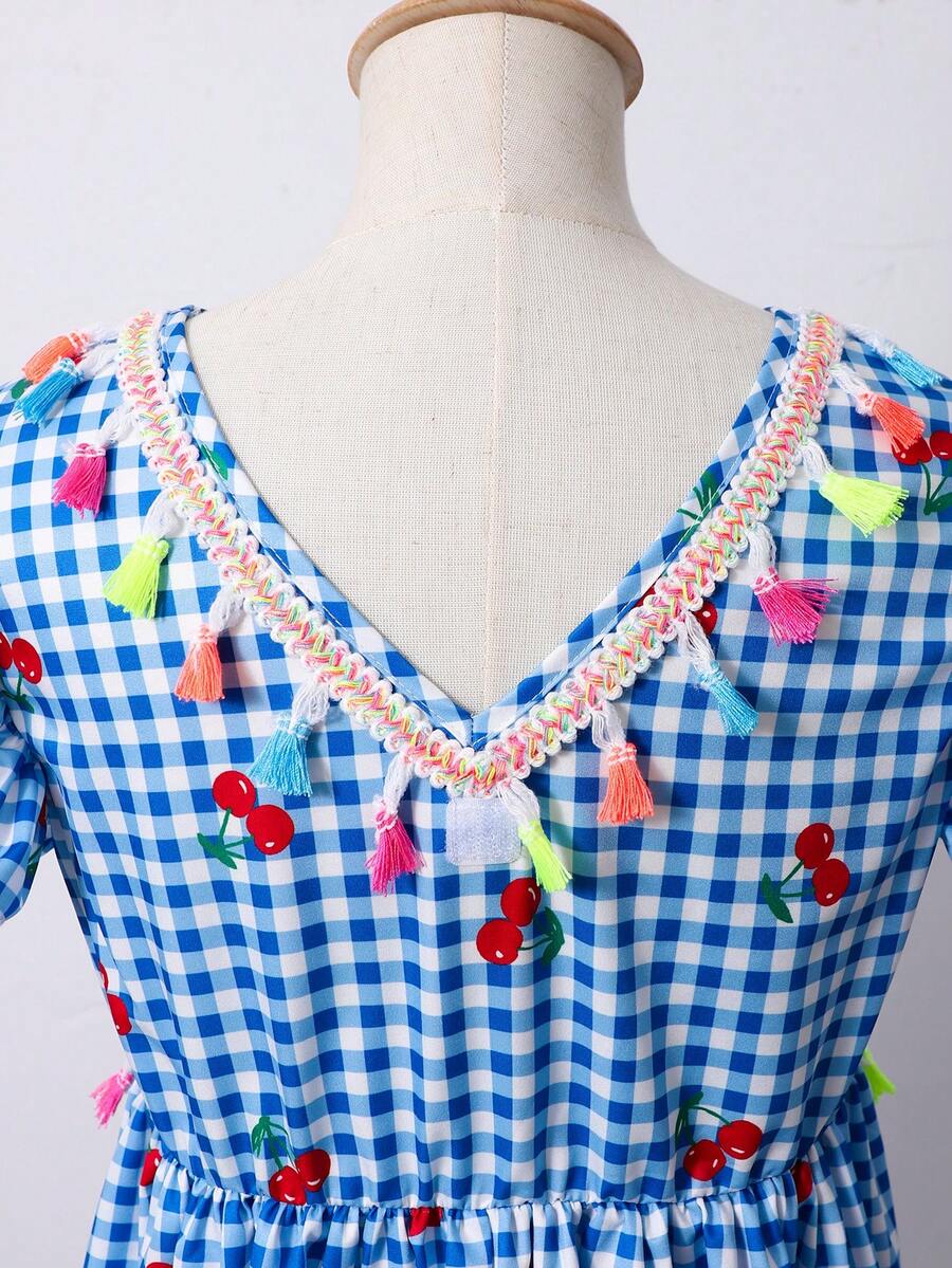 Tween girls blue short smock dress featuring flounce short sleeves, high waist flared hem, round neck, and front bow detail.