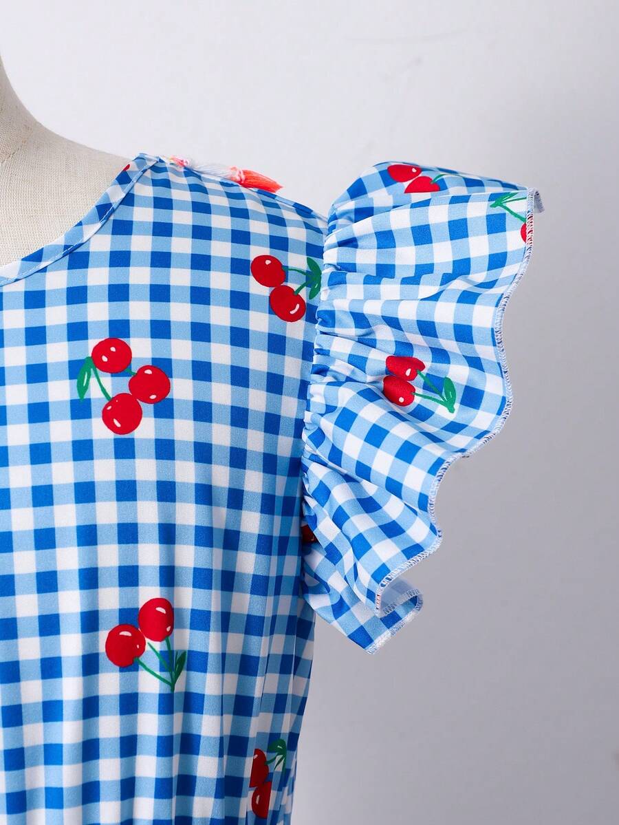Tween girls blue short smock dress featuring flounce short sleeves, high waist flared hem, round neck, and front bow detail.