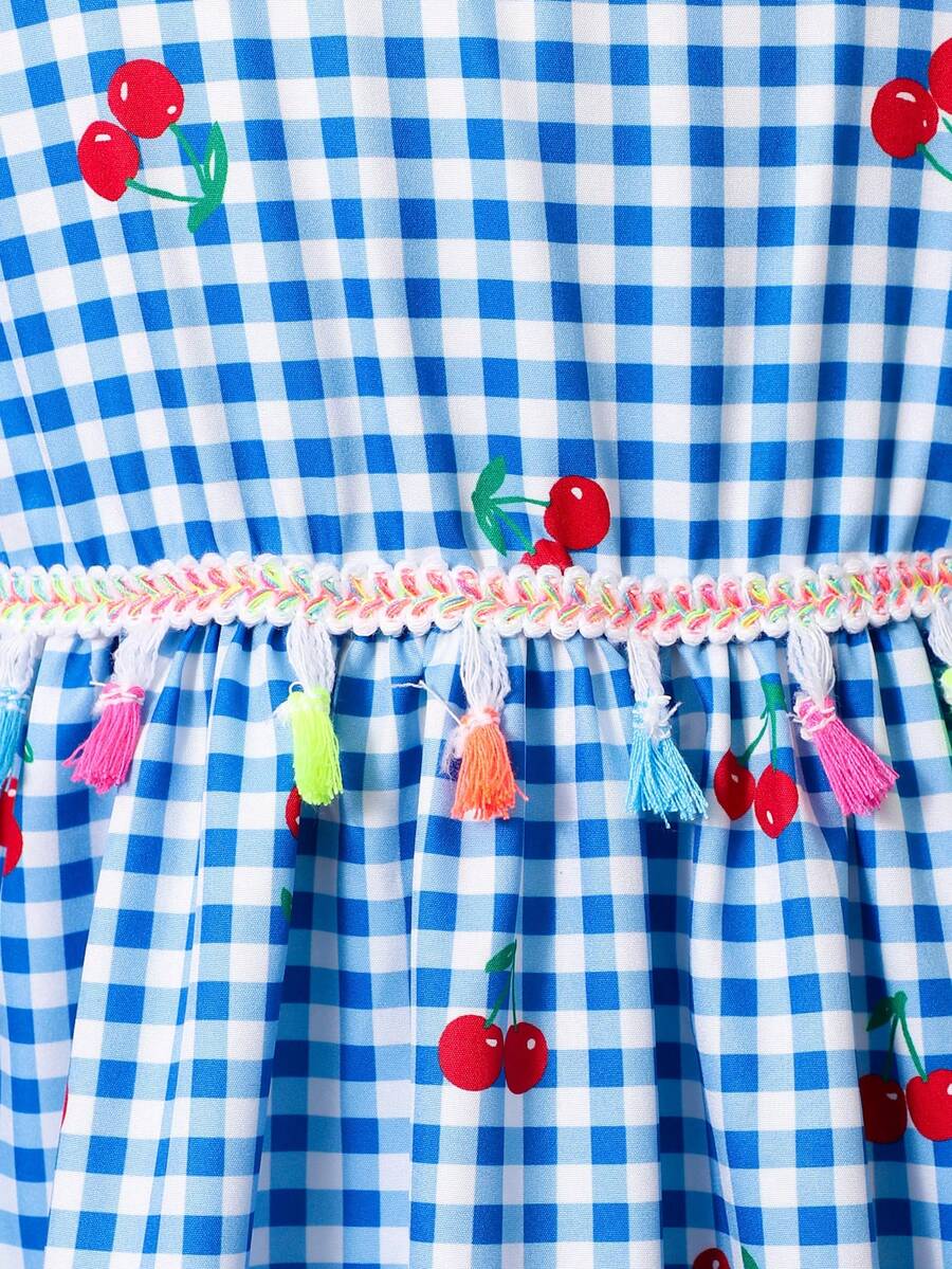 Tween girls blue short smock dress featuring flounce short sleeves, high waist flared hem, round neck, and front bow detail.