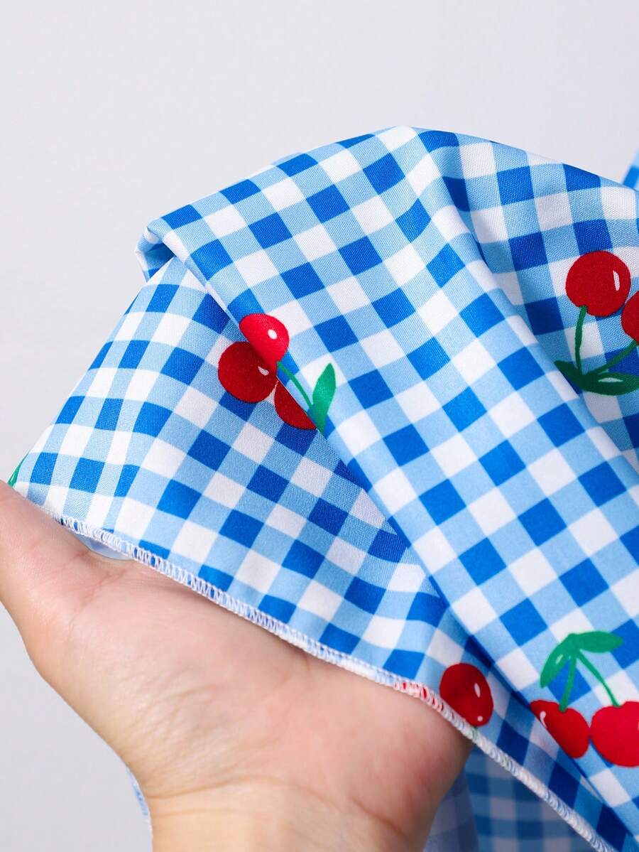 Tween girls blue short smock dress featuring flounce short sleeves, high waist flared hem, round neck, and front bow detail.