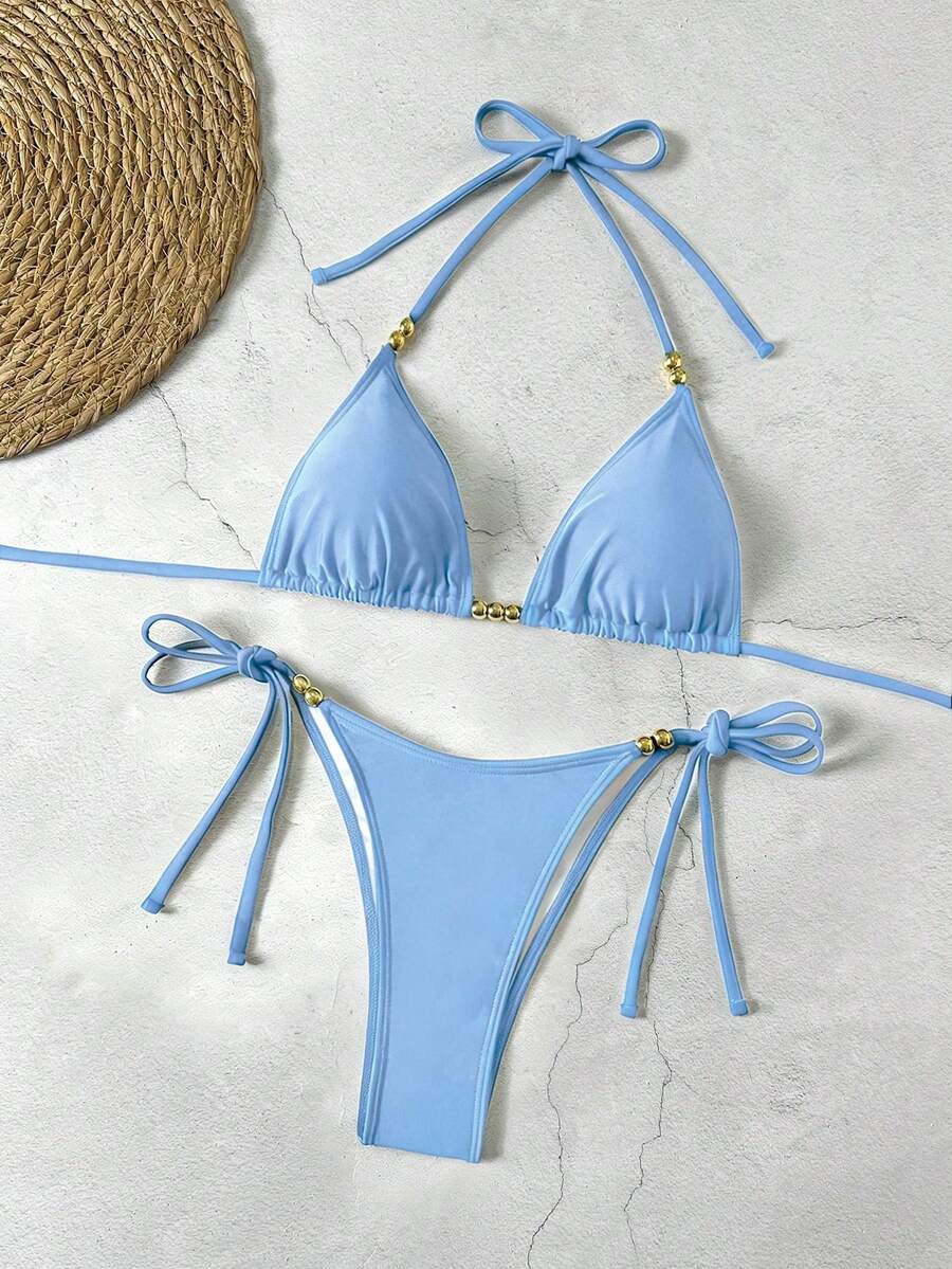 Women's black halter bikini set featuring triangle cups with gold bead decor and tie-back closure