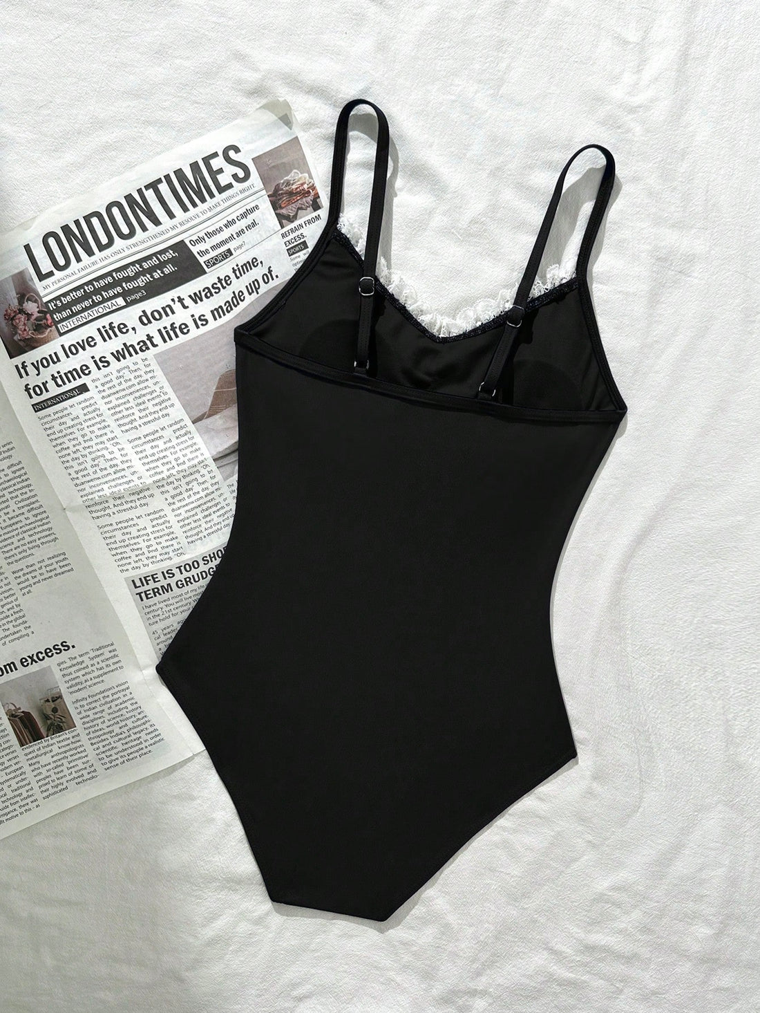 Tween girls' one-piece swimsuit featuring a ruffle splice front, ruched detailing, bow accent, contrast lace trim, and spaghetti straps.