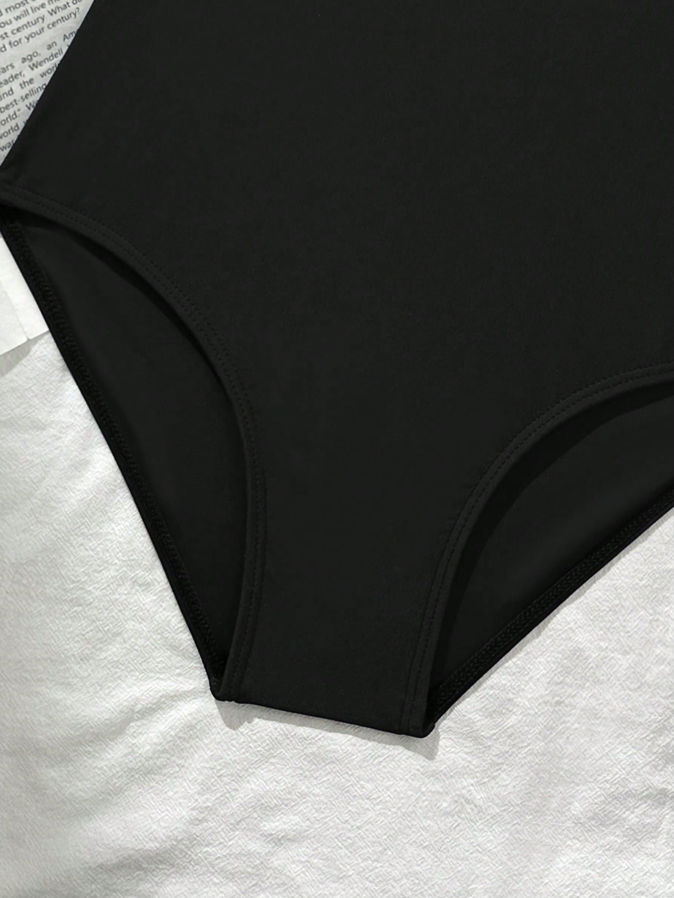 Tween girls' one-piece swimsuit featuring a ruffle splice front, ruched detailing, bow accent, contrast lace trim, and spaghetti straps.