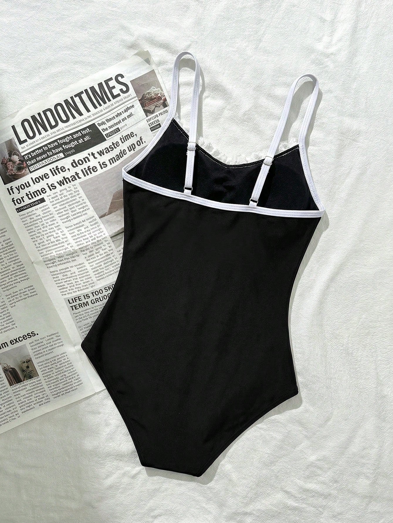 Tween girls' one-piece swimsuit featuring a ruffle splice front, ruched detailing, bow accent, contrast lace trim, and spaghetti straps.