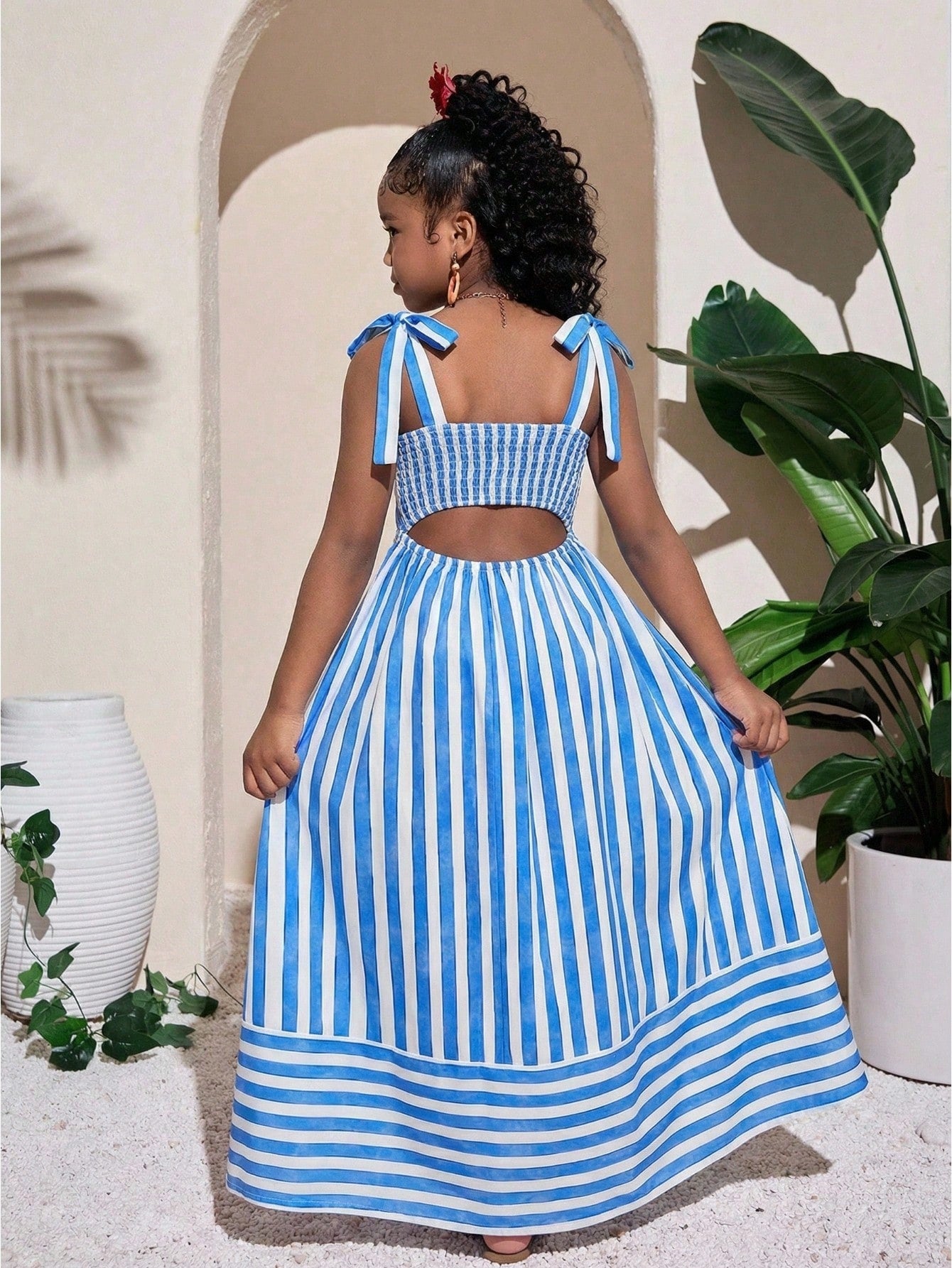 Tween girls blue striped summer camisole dress featuring spaghetti straps, high waist, flared hem, and back zipper detail.
