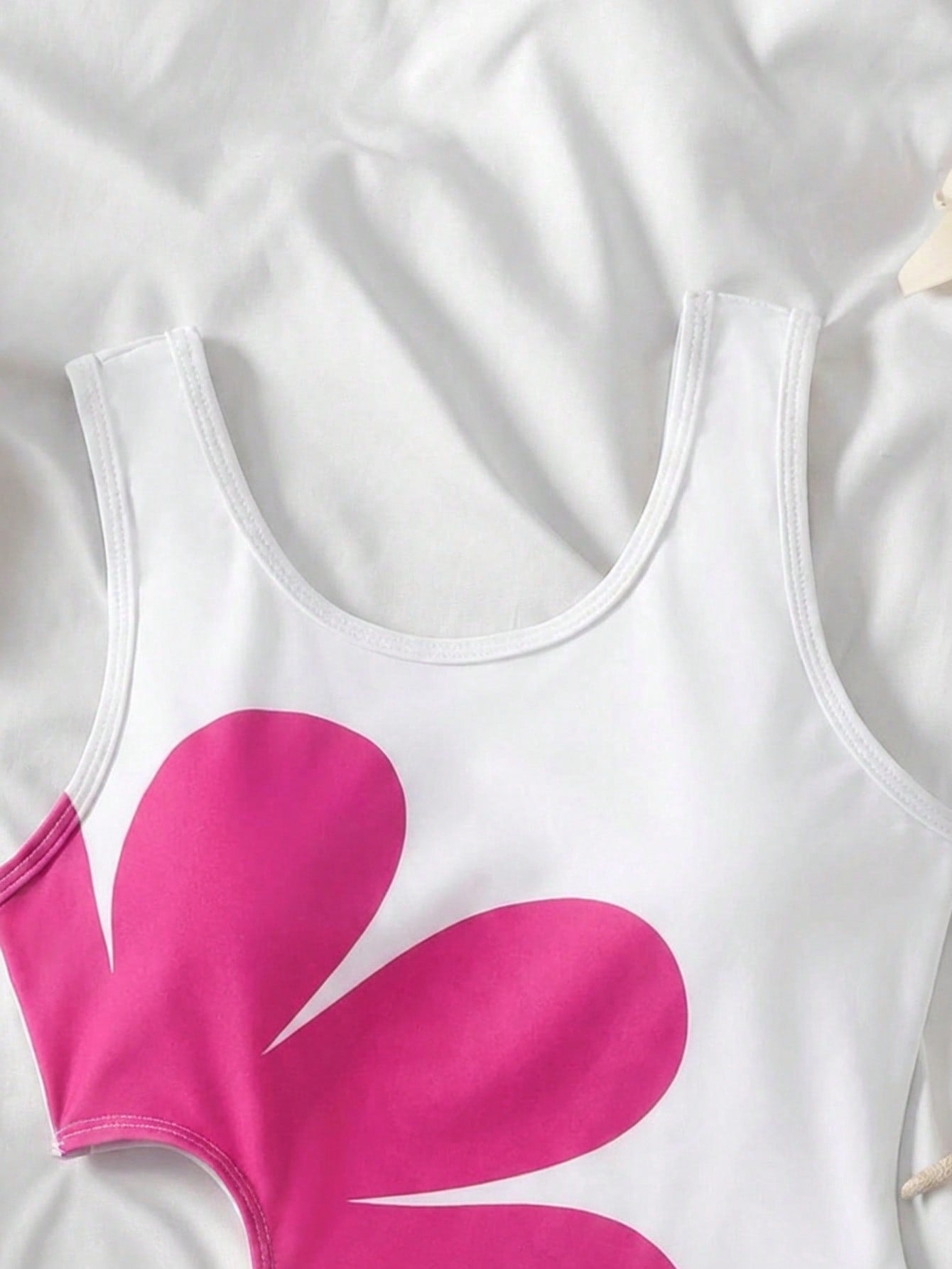 Tween girls' black and white one-piece swimsuit with striped patchwork design, scoop neck, asymmetrical cut-out detail, and fitted vacation swimwear style.